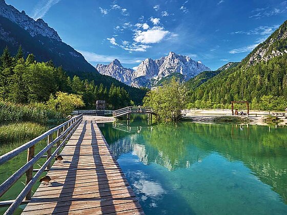 Blick auf den See mit einem Steg und Bergkulisse im Hintergrund